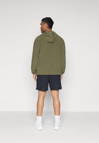 Under Armour VANISH SHORTS - Sportiniai šortai - black/morph green