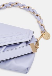 Purple leather handbag with a braided gold chain handle, featuring a flap closure and contrasting stitching details.