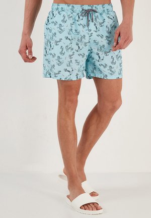 Pantaloni da bagno blu chiaro in poliestere, con un motivo ad ancora blu scuro. Vita elasticizzata con cordoncino per una vestibilità regolabile.