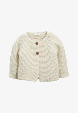 Kremowy dziergany kardigan z teksturowanym wzorem, okrągłym dekoltem i dwoma brązowymi guzikami z przodu. Długie rękawy raglanowe.
