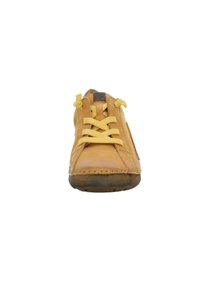 Leather sneaker in golden-yellow with textured surface, featuring yellow laces, a rounded toe, and stitched detailing along the sole.