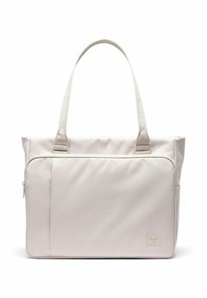 Sac fourre-tout beige clair avec deux poignées, une grande poche avant zippée, et une petite étiquette de marque en bas à droite.