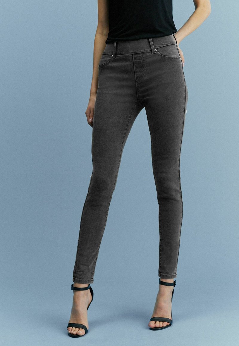 Graue hochgeschnittene Skinny-Jeans aus einem dehnbaren Baumwollmix, mit glatter Textur, subtiler Ausbleichung und Fünf-Taschen-Design.