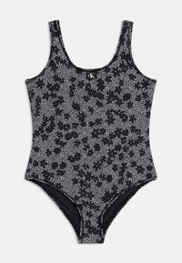 Μαύρο ολόσωμο μαγιό με λευκό πουά λουλουδάτο σχέδιο και λογότυπο CK στο κέντρο του στέρνου.