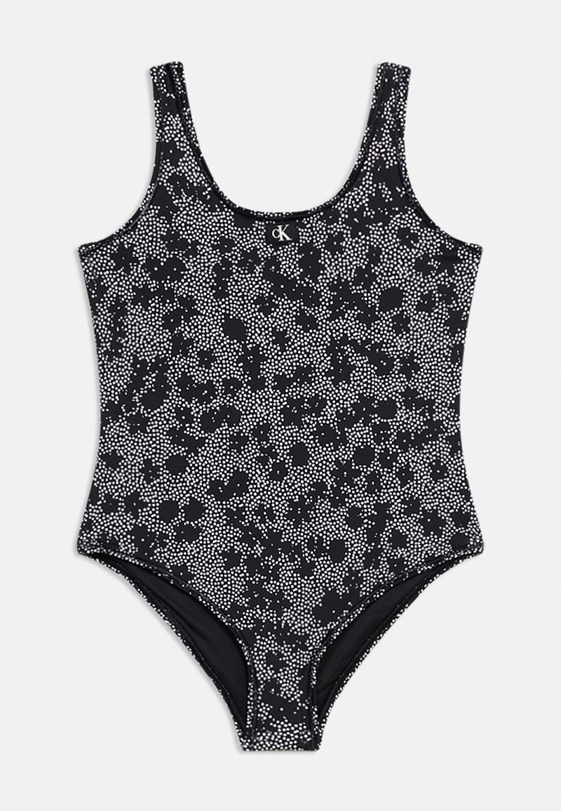 Μαύρο ολόσωμο μαγιό με λευκό πουά λουλουδάτο σχέδιο και λογότυπο CK στο κέντρο του στέρνου.