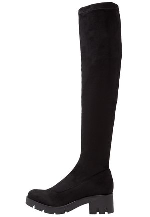 Botte noire au-dessus du genou avec semelle épaisse et talon bloc, fabriquée en matériau semblable au daim.