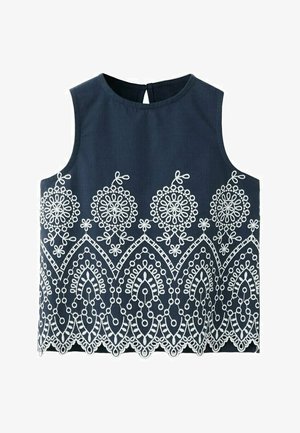 Haut sans manches bleu marine avec une broderie florale blanche circulaire et festonnée le long du bas et au milieu, doté d'une fermeture à boutons dans le dos.