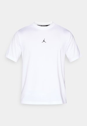 T-shirt de sport blanc en tissu lisse, avec un logo Jumpman noir au centre. Col rond et manches courtes.
