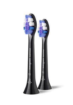 Twee zwarte Philips Sonicare S2 elektrische tandenborstelkoppen met blauwe, witte en paarse borstelharen staan rechtop op een witte achtergrond.