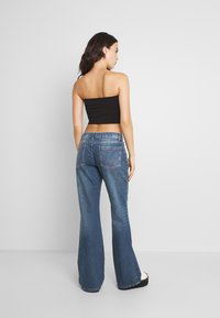 Jaded London LOW RISE BABY GIRL GRAFFITI PRINT - Calças de ganga bootcut - multi