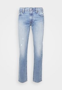 Jean slim bleu clair avec légère déchirure sur les cuisses et les poches, fermeture avant par bouton et fermeture éclair, passants pour ceinture et cinq poches.