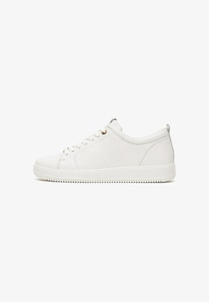 White low-top leather sneaker with lace-up closure, textured sole, and pull tab on heel, shown in side profile.