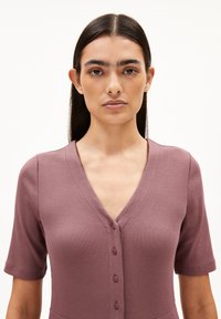 Ribbed, mauve dress with a V-neckline and short sleeves, featuring five buttons down the front. Smooth texture and fitted shape.