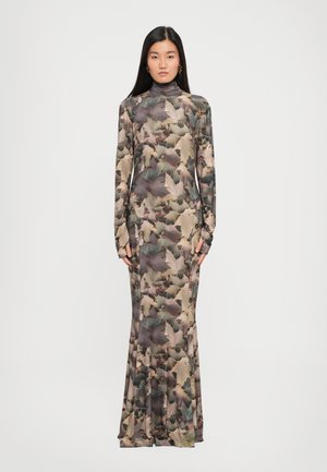 Long-sleeve dress in a fitted silhouette, featuring a leaf-patterned fabric in earthy tones of green, brown, and beige with a high neckline.