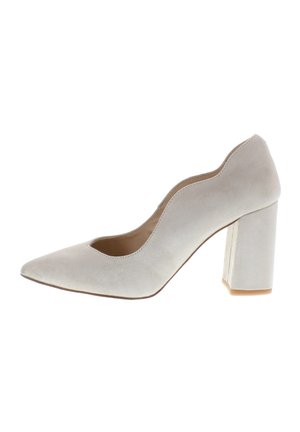 Women's beige suede pump with scalloped edge, pointed toe, and chunky block heel.