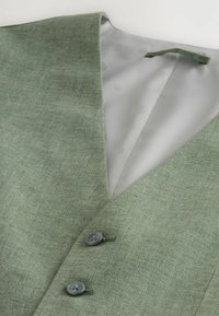 Green, textured vest with a V-neck, gray interior, and two gray buttons on the front. Smooth fabric lining visible inside.