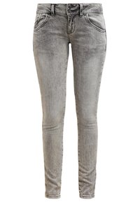 Jeans skinny en denim gris délavé, dotés d'un design classique à cinq poches, d'une fermeture à bouton et d'un léger effet usé pour un détail de texture.