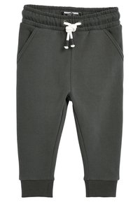 Pantaloni della tuta grigio scuro con vita elastica e cordino, dotati di due tasche laterali e polsini a costine alle caviglie. Texture morbida.