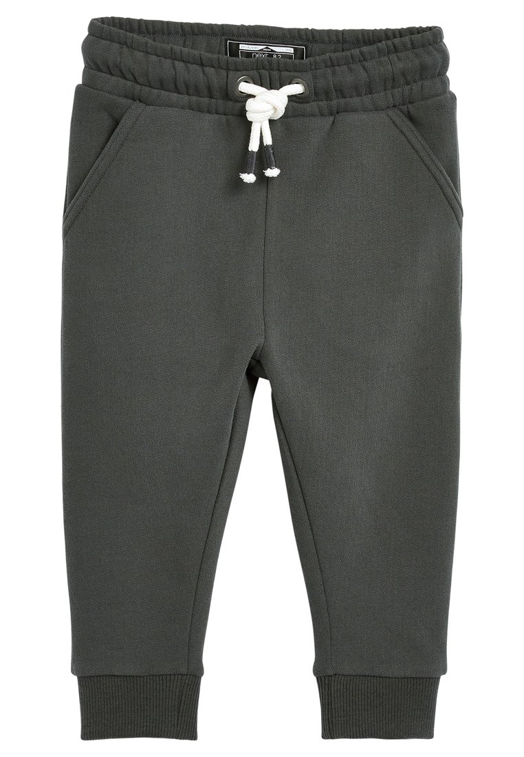 Pantaloni della tuta grigio scuro con vita elastica e cordino, dotati di due tasche laterali e polsini a costine alle caviglie. Texture morbida.