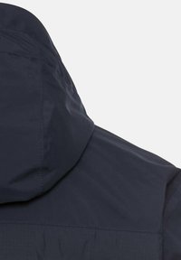 Navy blue jacket with a hood, featuring a smooth texture and subtle sheen. Seam details visible on the shoulders and upper back.