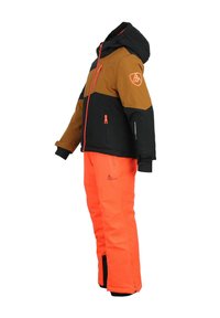 Veste de neige avec un design coloré en blocs de marron et noir, accents orange, poches zippées, accompagnée de pantalons de neige orange assortis.