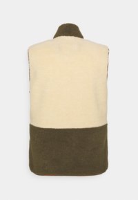 Fleece-Weste mit einem cremefarbenen oberen Bereich und einem dunkelgrünen unteren Abschnitt, mit hohem Kragen und einer strukturierten, gemütlichen Oberfläche.