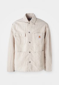 Beige work jacket made of durable fabric, features a snap button front, two chest pockets, and a logo patch on the left pocket.