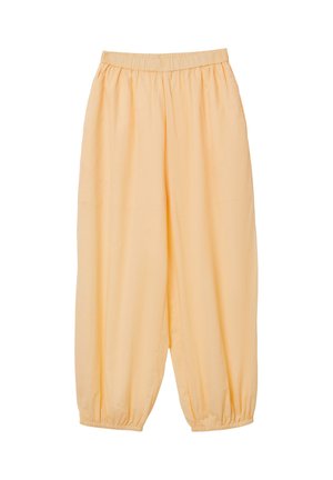 Pantalon ample de couleur orange clair avec taille élastique et poignets élastiques aux chevilles, fabriqué en tissu lisse et léger.