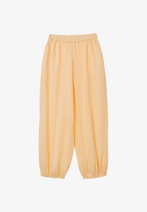Pantalon ample de couleur orange clair avec taille élastique et poignets élastiques aux chevilles, fabriqué en tissu lisse et léger.