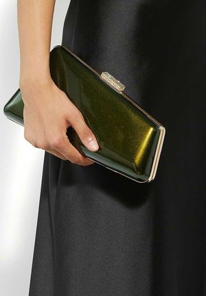 Green metallic clutch purse with a sleek rectangular shape, gold hardware closure, held in a hand. Smooth, glossy texture.