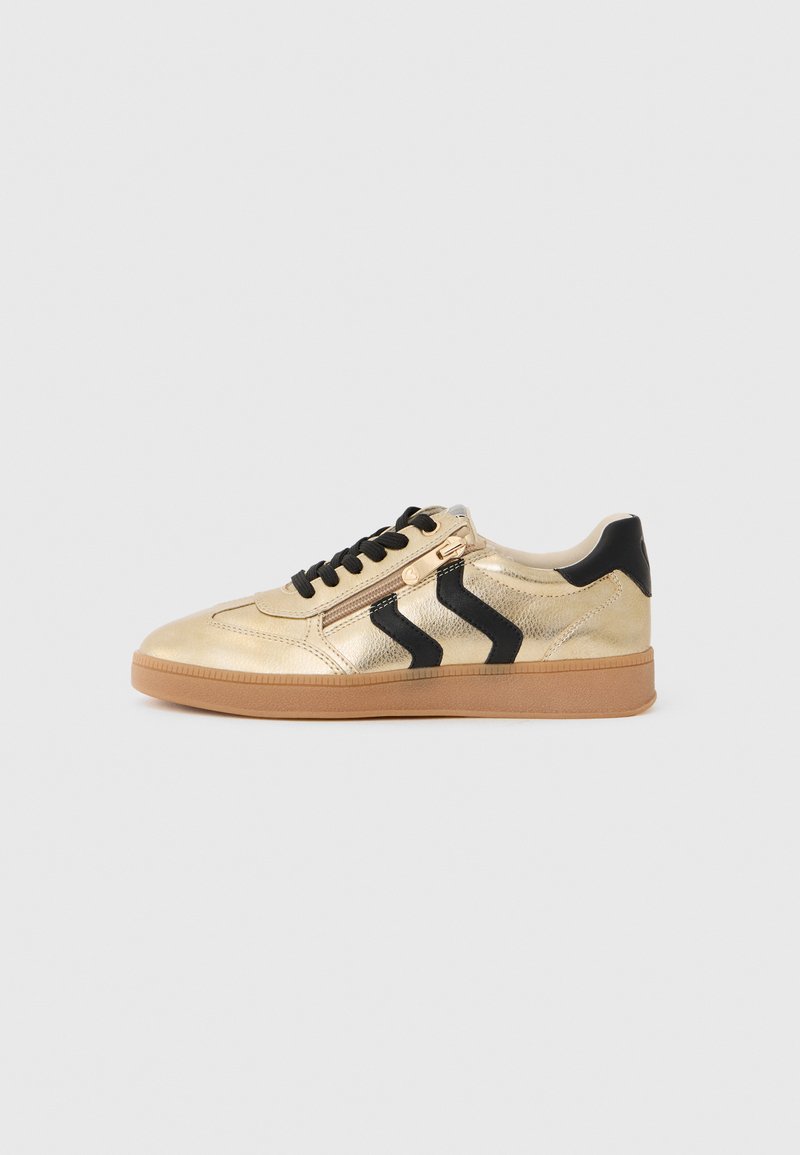 Sneaker metallico dorato con accenti neri e design a zigzag, dotato di lacci neri e suola in gomma naturale. Chiusura laterale con zip per indossarlo facilmente.