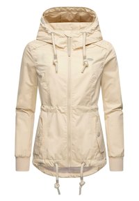 Beige huva jacka gjord av slät nylon. Har dragsko vid midjan och huvan, ribbade manschetter och dragkedja fram med fickor.