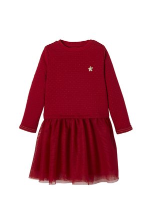 Red long-sleeve dress with a textured top, gold star embellishment on chest, and a layered tulle skirt.