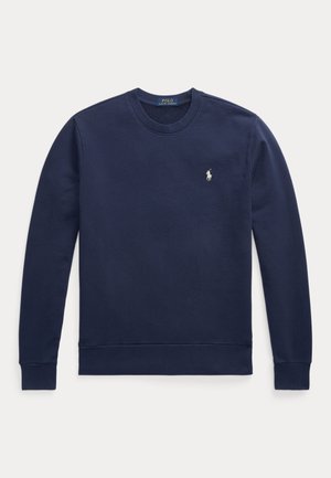 Mørkeblå sweatshirt laget av myk stoff, med rund hals, ribbestrikkede mansjetter og en liten hvit broderte logo på brystet.