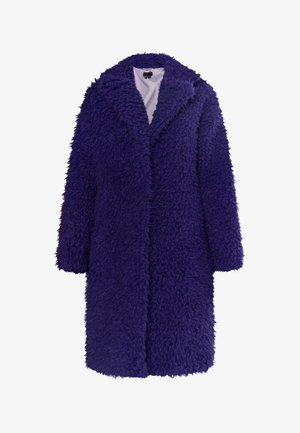 Pitkä, violetti tekoturkistakki, jossa on taitettu kaulus, ylisuurta muotoa ja teksturoitu pinta. Takissa on yksi etuaukko ilman nappia.