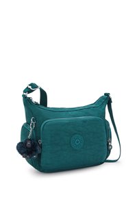 Borsa a tracolla turchese con tasca frontale con zip, tracolla regolabile e piccolo portachiavi a forma di gorilla in peluche attaccato alla zip laterale.