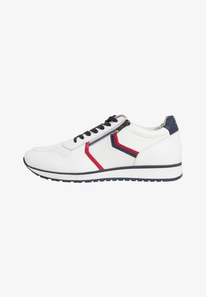 White sneaker with black laces and a side zipper; features red and navy accents, a textured mesh upper, and a white rubber sole.
