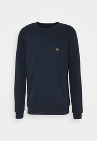Navy blue sweatshirt made of soft fabric, featuring a crew neckline, long sleeves, and a small square logo patch on the chest.
