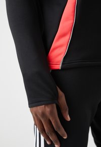 adidas Performance TIRO 24 WINTERIZED - Sportska majica - black/shock red