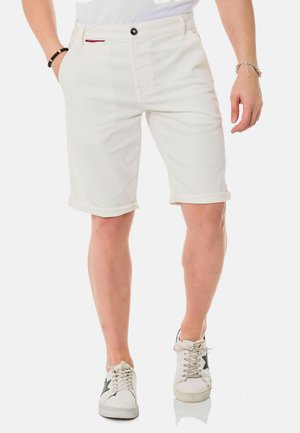 White denim shorts with rolled cuffs, featuring a front pocket, black button closure, and a small red label on the waistband.