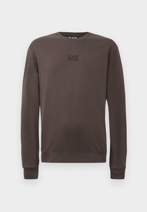 Ruskea pitkähihaine collegepaita, joka on valmistettu pehmeästä kankaasta. Siinä on pyöreä kaula-aukko, ribbaatut hihansuukkeet ja pieni musta logo rinnassa.