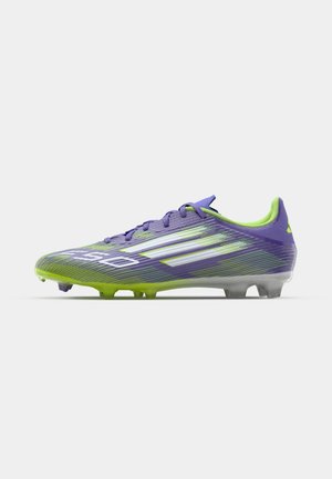 Vibrant purple and green soccer cleat with dynamic diagonal stripes, featuring a textured upper, lightweight design, and translucent sole.