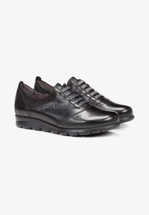 Zapatos de cuero negro con un acabado suave, cordones elásticos y punta redondeada. Presentan una suela acolchada para mayor comodidad y durabilidad.