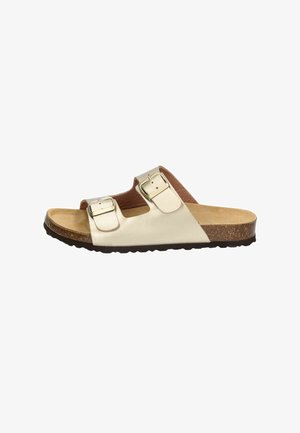 Beige open-toe sandal with two adjustable buckle straps, cork footbed, and black textured sole, shown from the outer side.