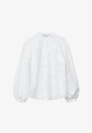 Blouse blanche avec broderie florale, fermeture à boutons, col montant et manches bouffantes. Confectionnée en tissu texturé avec une sensation douce et légère.