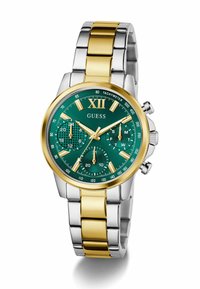Montre en métal argent et or avec un cadran vert, dotée de trois sous-cadrans, d'index horaires en or et d'une lunette tachymétrique. Marque : Guess.