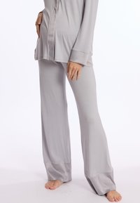 Ensemble de vêtements d'intérieur gris clair comprenant un haut à manches longues et un pantalon fluide, fabriqué dans un tissu doux et lisse avec des poignets en satin.