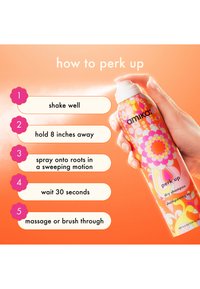 Le shampoing sec Amika Perk Up dans une bombe vive présente un design floral coloré. Les instructions d'utilisation sont affichées à côté.