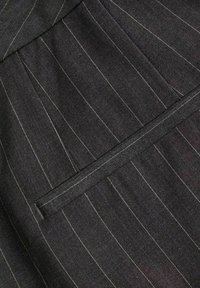 Gray fabric with narrow vertical white and blue stripes, featuring a stitched detail and a concealed zippered pocket. Textured finish.