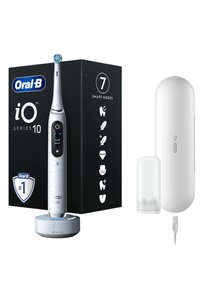 Brosse à dents électrique avec un design blanc tacheté, un panneau de contrôle noir, une base de chargement, une housse et un emballage présentant des icônes pour sept modes.
